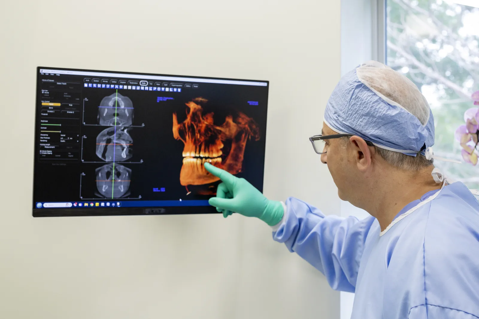 Dr. Gus Dehni reviewing a cone-beam CT scan